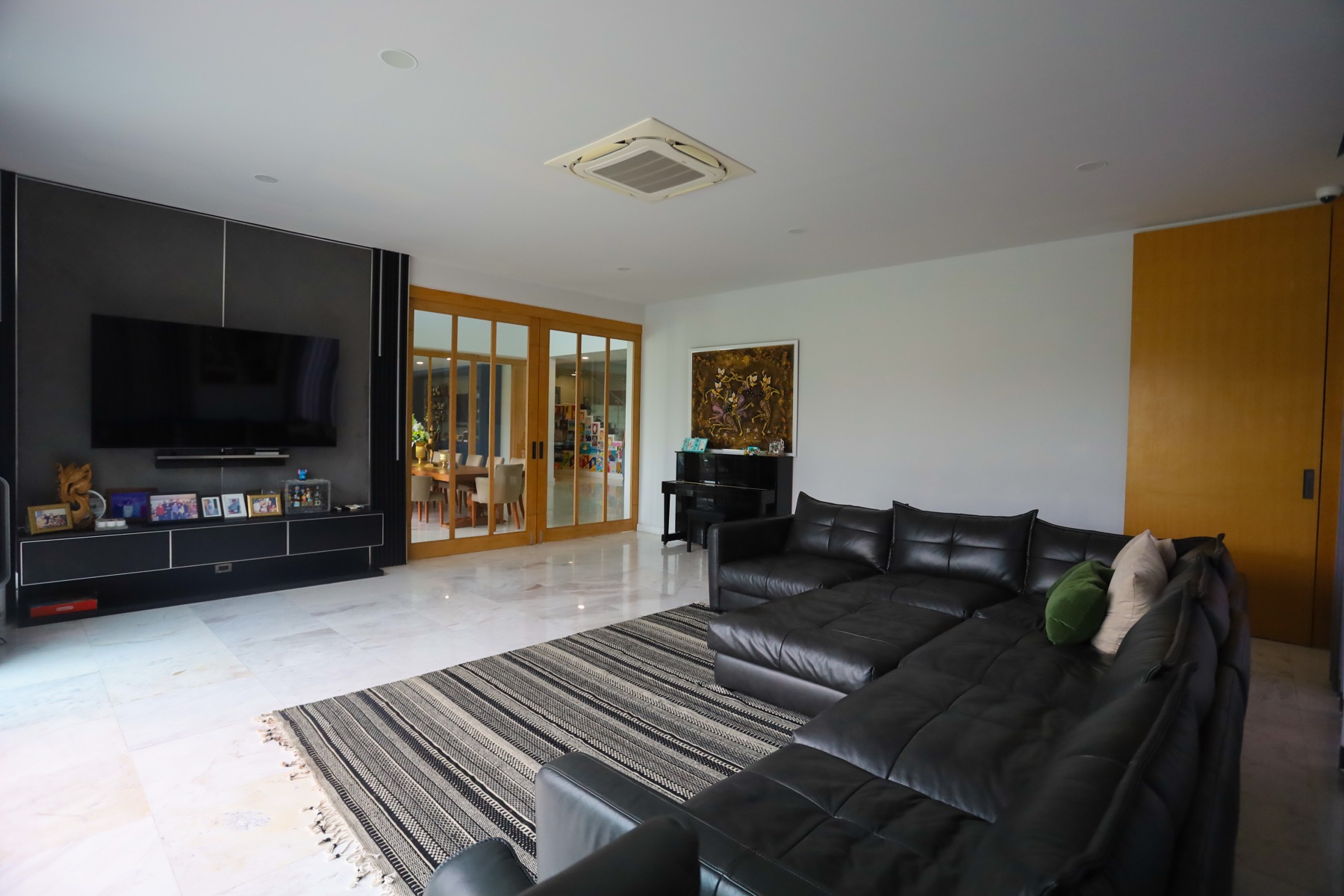 Family room with marble floors opening through to the dining area